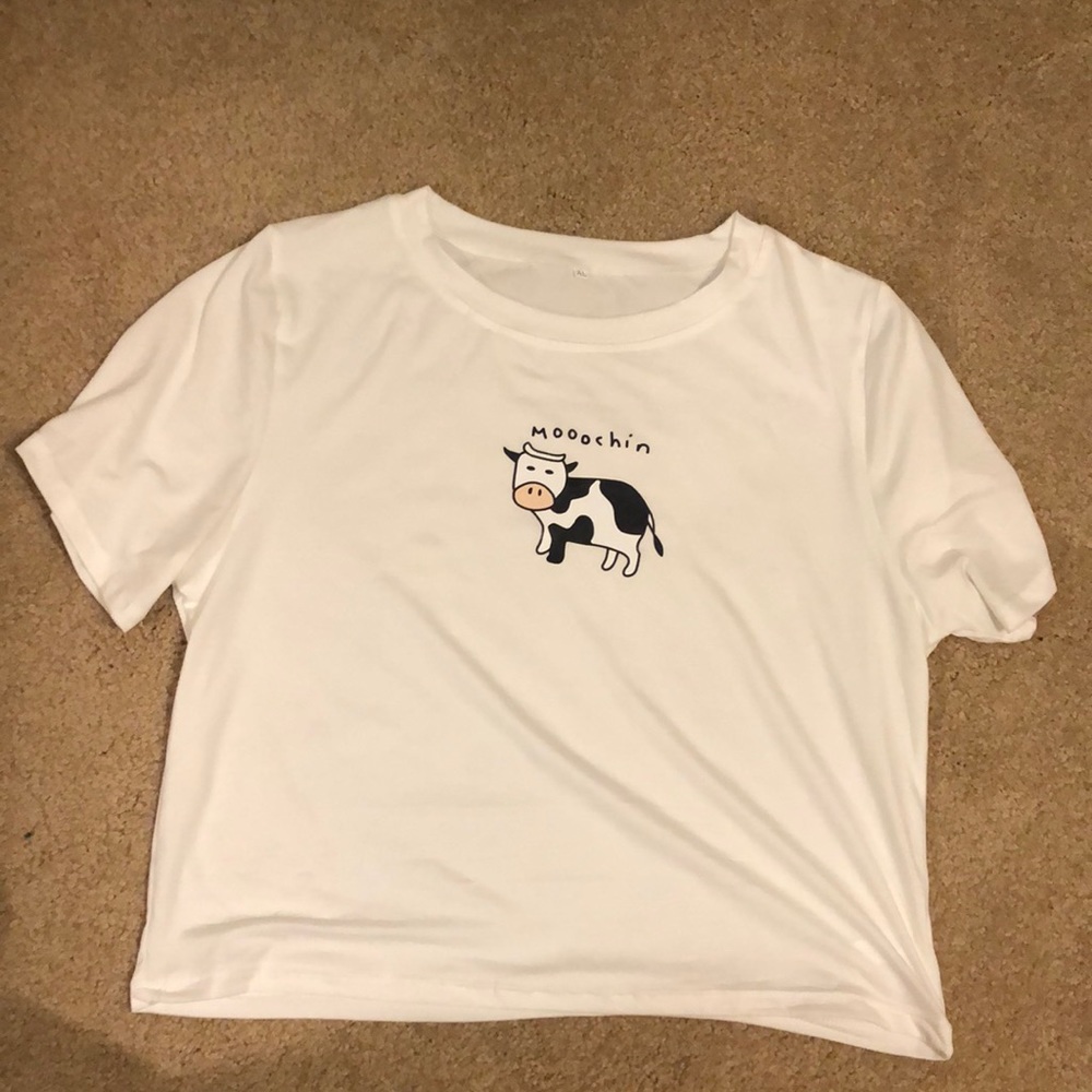 White shirt with cow that says “moochin”